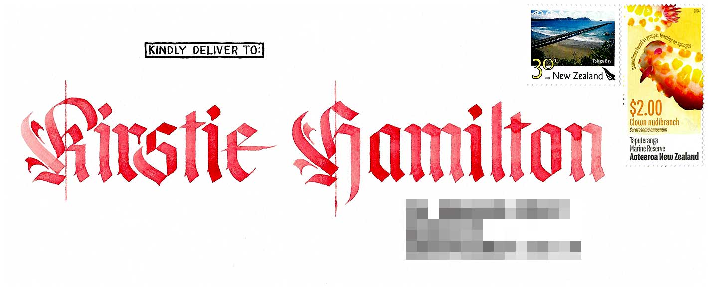 An envelope addressed to Kirstie Hamilton in red blackletter calligraphy.