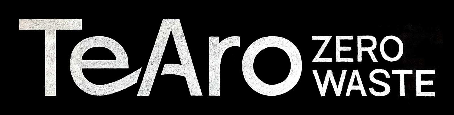 The words "Te Aro Zero Waste" written in white chalk on a black chalkboard.